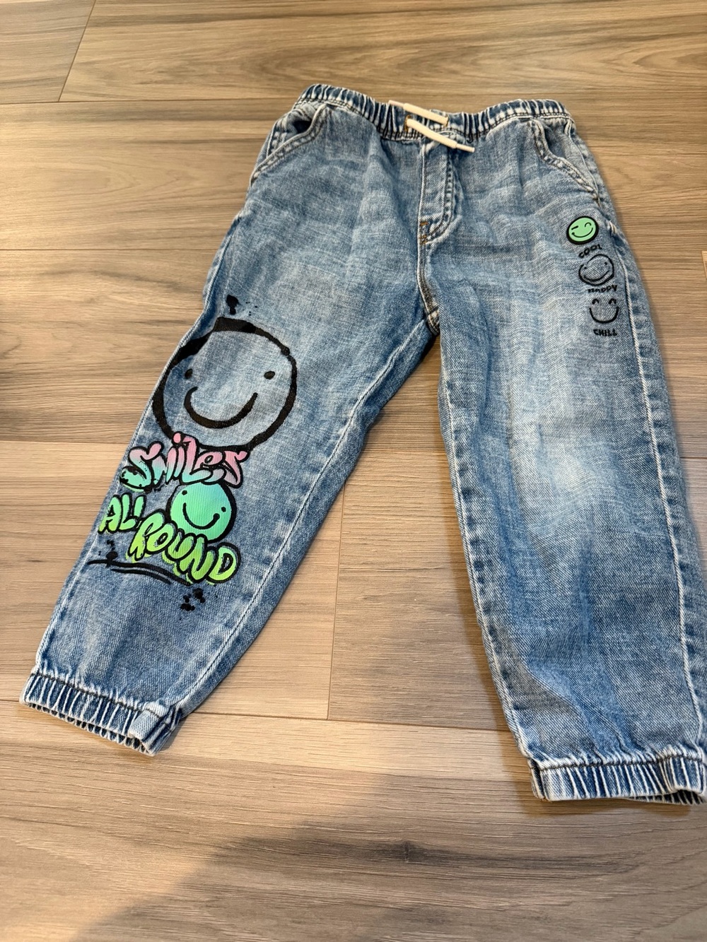 next Light Wash Denim Joggers with Green & Pink Smiley Graphics